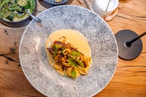 a plate of food with pasta on a table at Kapama River Lodge in Kapama Private Game Reserve