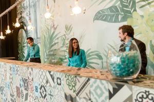 a group of people standing in front of a mirror at Motel One Barcelona-Ciutadella in Barcelona