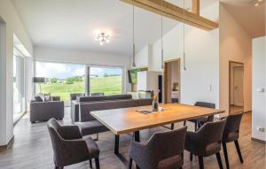 a dining room and living room with a table and chairs at Villa Mit Pool In Stegersbach in Neudauberg