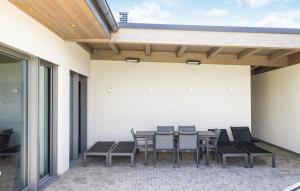 a patio with a table and chairs on it at Villa Mit Pool In Stegersbach in Neudauberg +24 photos