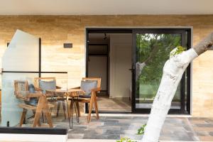 a patio with a table and chairs in front of a house at Garden Inn in Himare