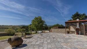 a stone patio with a gazebo and a building at Kochab Sintra by LovelyStay in Sintra