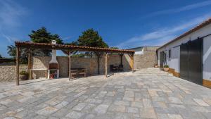 an outdoor patio with a pergola next to a building at Kochab Sintra by LovelyStay in Sintra