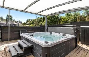 a hot tub on the deck of a house at Beautiful Home In Ebeltoft With Wifi in Ebeltoft