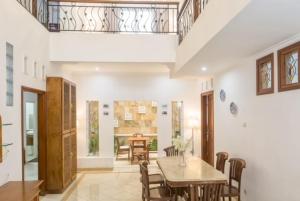a dining room with a table and chairs at DD House Malang in Jenggrik
