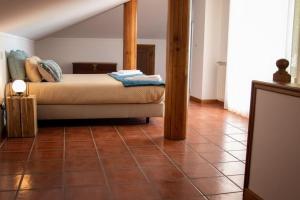 a bedroom with a bed and a tiled floor at Casa Colibry in Marinhas +7 photos