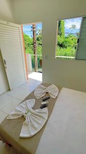 a room with a table with two bows on it at Pousada Eco Beach in Ubatuba +23 photos