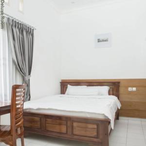 Ένα ή περισσότερα κρεβάτια σε δωμάτιο στο DD House Malang