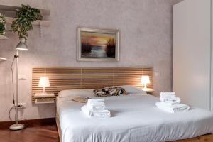 a bedroom with a large bed with towels on it at Le Margherite - Sweet Dreams in Florence in Florence