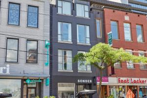 a group of buildings on a city street at Sonder The Beverley in Toronto