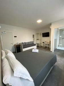 a bedroom with a large bed and a television at Boutique Hotel Nuovo Cason in Cavallino-Treporti