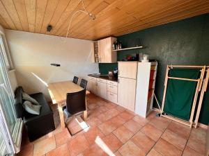 a small kitchen with a table and a refrigerator at Ferienwohnung Spitzenberger in Furth im Wald