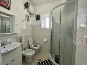 a bathroom with a toilet and a sink and a shower at Casa vacanze da Tonino in Noci