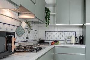 a kitchen with white cabinets and a stove at Le Margherite - Sweet Dreams in Florence in Florence