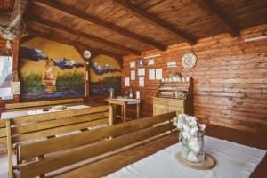 a church with wooden walls and benches in a room at Casa Mister in Sulina
