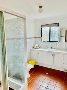 a bathroom with a toilet and a glass shower at Super spacious Fremantle Villa 3 Bedrooms 3 Bathrooms in Fremantle