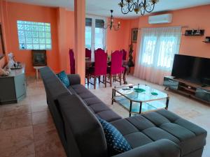 a living room with a couch and a table at kali SunnySide Up in Nea Kallikrateia