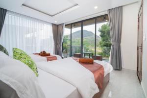 En eller flere senge i et værelse på Ban Ban Resort TeukChhou
