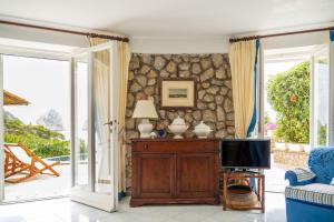 TV a/nebo společenská místnost v ubytování Villa Roccia Di Mare
