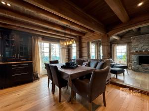 a dining room with a table and a couch at Newer lovely cabin in Birkebeinerbakken Sjusjøen in Ringsaker