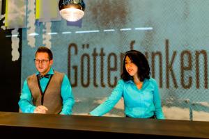a man and a woman standing at a table at Motel One Bonn-Beethoven in Bonn
