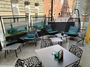 a patio with chairs and tables in a restaurant at Motel One Bonn-Beethoven in Bonn