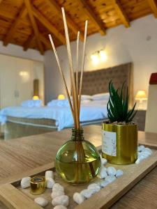 a vase with plants in it sitting on a table at Harmonia Bungalows & Pool in Sveti Stefan
