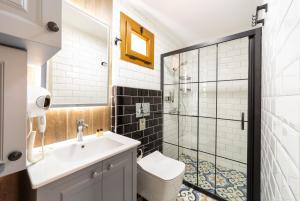 a bathroom with a toilet and a sink and a shower at Orange Garden Hotel Akyaka in Akyaka +53 photos