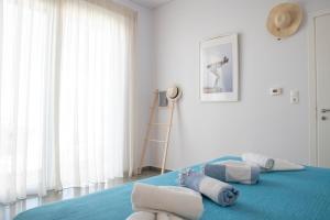 Un dormitorio con una cama azul con toallas. en Villa Kassandra, en Pitsidia 97 fotos más