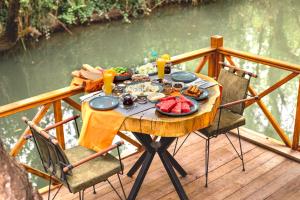 a table with food and drinks on a deck at Orange Garden Hotel Akyaka in Akyaka