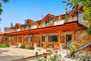 an apartment building with balconies and flowers at Orange Garden Hotel Akyaka in Akyaka