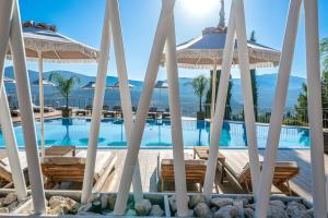 a view of a swimming pool with umbrellas at The "L" Suites & Apartments in Argostoli