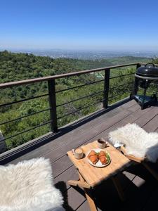 a table on a deck with a plate of food on it at SweeDom Shale in Almaty