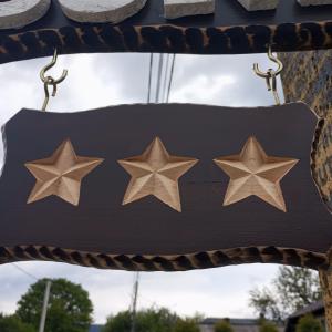 a cushion with four stars hanging from awning at Căsuța Bunicilor in Dorna Cîndrenilor
