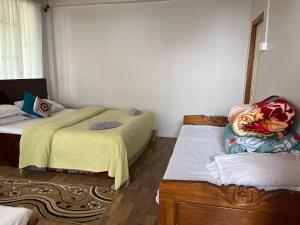 Postel nebo postele na pokoji v ubytování swastik homestay + 3 fotografie
