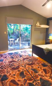 a bedroom with a bed and a large glass door at Margaret Retreat Pet Friendly Unit in Margaret River Town