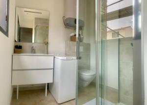 a bathroom with a toilet and a sink and a shower at Résidence 3 étoiles Pietra Gemina - Appartements de vacances, au calme, avec Piscine in Calenzana +87 photos