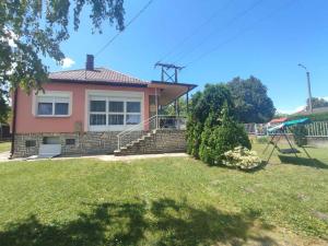 a house with a yard with a swing at Holiday home in Fonyod - Balaton 18592 in Fonyód