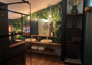 a bathroom with two sinks and a large mirror at Antico Casale Formica in Bagheria