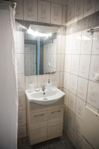 a bathroom with a sink and a mirror at Happy Room-2' from sea in Kalamata