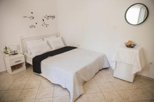 a bedroom with a bed and a mirror and a table at Happy Room-2' from sea in Kalamata