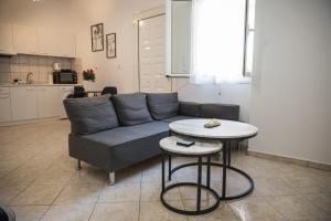 a living room with a couch and a table at Happy Room-2' from sea in Kalamata