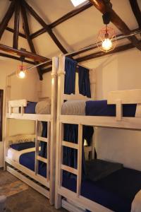a bedroom with three bunk beds in a room at Usaquen Station Hostel in Bogotá