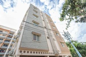 a tall building with a gray roof at Collection O Royal Mac in Bangalore