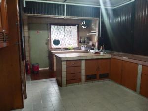 a large kitchen with a sink and a window at AnNur Homestay in Lahad Datu