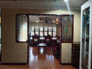 a living room with a couch and a table at AnNur Homestay in Lahad Datu