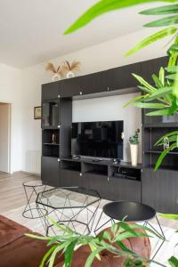 a living room with two chairs and a fireplace at Charme de Bollwiller in Bollwiller