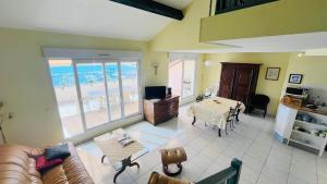 a living room with a couch and a table at Appartement SANTA REGINA 3 Calvi in Calvi