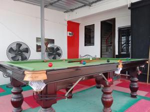 a room with a pool table with balls on it at BEN & LEK GUESTHOUSE in Pattaya South