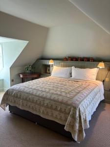 a bedroom with a large bed and two lamps at Hootananny in Inverness